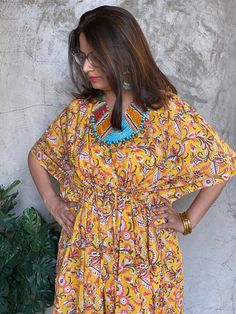 I have a deep fondness for making kaftans as they offer unparalleled comfort. This particular one is crafted with hand block printed cotton, adding a touch of uniqueness. This particular style features a drawstring waist, providing a flexible fit that accommodates up to 4xl sizes. If you need it to be maternity-friendly or nursing-friendly, I can add buttons in the front. You have the option to choose this feature at the time of checkout.  You also have the option to add pockets for an additional charge of $5. Kindly select this option during the checkout process. The best part is that it fits everyone perfectly, so you don't need to worry about sizes.  The shown length is ankle length, but I can customise it to knee or calf-length based on your height. You can select this option during ch Multicolor Block Print Kaftan For Vacation, Yellow Cotton Kaftan For Vacation, Bohemian Cotton Kaftan With Block Print, Free Size Block Print Kaftan, Cotton Kaftan With Ikat Print, Block Print Free Size Kaftan, Yellow Block Print Dresses For The Beach, Yellow Block Print Dresses For Beach, Bohemian Yellow Kaftan With Batik Print