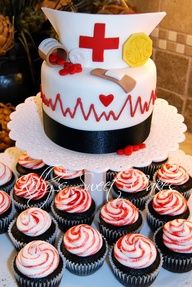 cupcakes are arranged in front of a cake with a nurse's hat on top