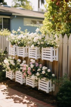 white picket fence with flowers growing on it