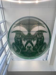 a sculpture made out of legos in the shape of a bear with green eyes