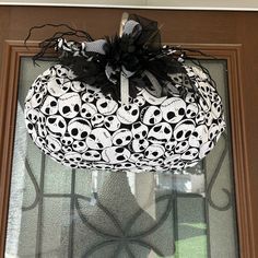 a door hanger decorated with skulls and black ribbon