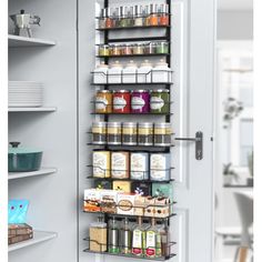 the pantry door is open to reveal an assortment of spices and condiments in it