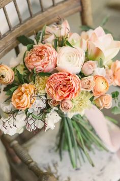 a bouquet of flowers sitting on top of a wooden chair