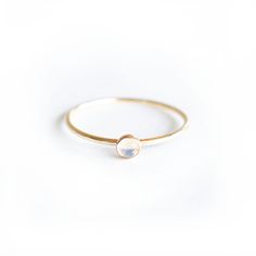 Introducing our Gold Tiny Moonstone Ring featuring a stunning 3mm hand picked Moonstone. Each stone is unique and since these are natural Moonstones , no two stones will ever be the alike. This ring is handmade with a 14k Gold filled ring and a stunning natural Moonstone set in a gold filled bezel. Available in size 4 - 11 Gold Moonstone Ring, Memorial Ring, Jewelry Wedding Rings, Gold Filled Ring, Memorial Jewelry, Engraved Items, Moonstone Ring, Ring Gold, Gold Gold