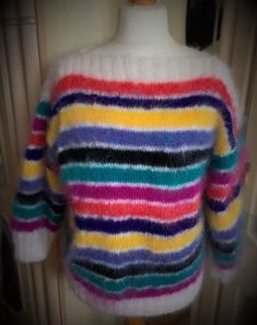 a multicolored sweater on a mannequin head