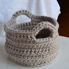 a crocheted basket sitting on top of a table