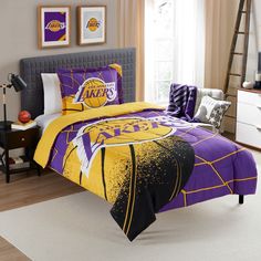 a bed room with a basketball themed comforter and pillows