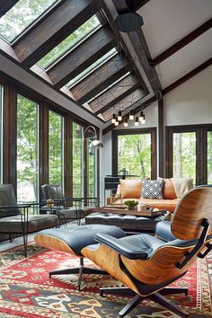 a living room with lots of windows and furniture on the floor, including an egg chair