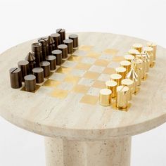 Designed by London-based Studio ANANSI with a minimalist sensibility, travertine game table makes a striking statement. Crafted of honed white travertine with an unlacquered brass inlay, the table is characterized by two carved cutouts on the base. Perfect for chess or checkers, the table's smaller scale makes it easy to style as a side table when not in play. Paired with polished unlacquered brass and blackened brass chess pieces. CB2 exclusive.Due to the nature of the material, brass patina wi Chess Side Table, Minimalist Chess Set, Chess Party, Card Table, Game Table, Grey Faux Fur Throw, Stone Chess Set, Marble Bistro Table, Garage Game Rooms