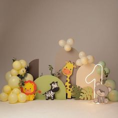 a table with balloons and animals on it