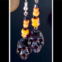 Ready For Halloween, These Handmade Earrings Feature Black Ceramic Skulls With Orange Ceramic Evil Eye Cylinder Beads, Accented By Orange And Glass Seed Beads. Length From Tops Of Silver Tone Hooks 2.8". Halloween Skull Print Earrings, Handmade Spooky Black Earrings, Handmade Black Halloween Earrings, Handmade Black Skull Earrings, Halloween Black Beaded Jewelry, Adjustable Black Skull-shaped Earrings, Adjustable Black Skull Earrings, Black Skull Print Earrings As Gift, Handmade Black Jewelry For Day Of The Dead