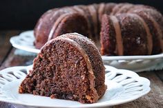 a bundt cake on a plate with one slice cut out and the other half eaten