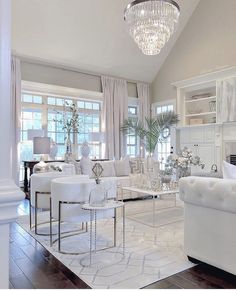 a living room filled with furniture and a chandelier