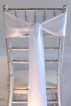 a chair with a white sash tied to it