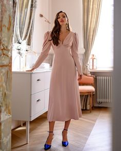 Fabric: Heavy Satin Cotton 50%, Polyester 50% V-neck dress Puffed sleeves Long sleeves Bow on back detail Zipper on back Dress lenght: 125 cm/ 49,2 inSleeve length: 68 cm/ 26,7 in Colors: White, Sky-Blue, Dusty Pink Vneck Weddingdress, Midi Pink Dress, Backless Midi Dress, Wear Store, Halter Midi Dress, Dress Dusty, Bow Back, Puff Sleeve Dresses, Pink Midi Dress