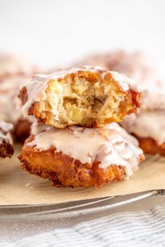 glazed donuts stacked on top of each other with icing drizzled over them