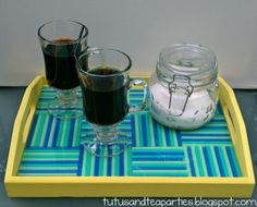 two glasses of coffee on a yellow tray