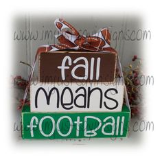 a wooden sign that says, fall means football with a bow on the top and bottom