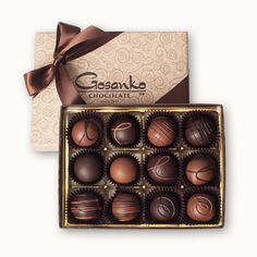 a box of chocolates with a brown ribbon