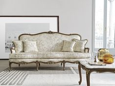 a living room filled with furniture and a painting on the wall above it's headboard