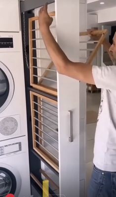 a man is working on an oven in the kitchen