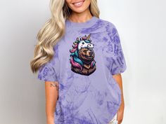 Embrace your wild side with our unique "Bear in Unicorn Mask" T-Shirt! Featuring a detailed illustration of a bear wearing a colorful unicorn mask, this design combines whimsy and strength. Perfect for animal lovers and fans of magical creatures, this shirt is made from soft, high-quality fabric for ultimate comfort and durability. Express your quirky style and add a touch of fantasy to your wardrobe. Available in various sizes. Product Features: Fabrication: 100% ring-spun cotton. Medium fabric Elephant Dress, Animal Graphic Tee, Unicorn Tshirt, Cute Corgi, Whimsical Fashion, Cute Funny Dogs, A Unicorn, Magical Creatures, Animal Shirts