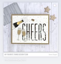 a card that says cheers with two champagne glasses