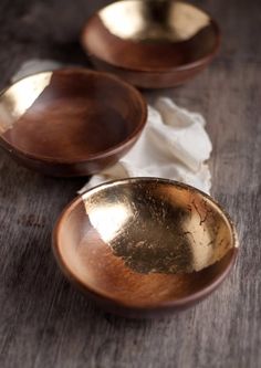 two brown bowls sitting on top of a wooden table