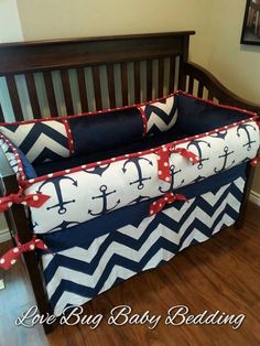 a baby crib bedding set with anchors and chevrons on navy blue