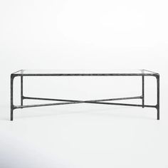 a glass and metal coffee table against a white background with no one around it,