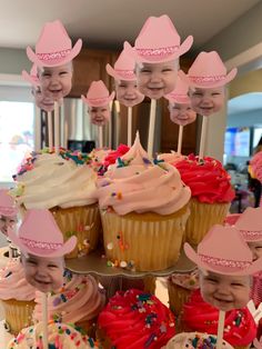 cupcakes with pink frosting and hats on them