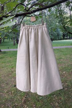 Your Story is a linen midi wide skirt with pockets, and a stitching elastic band at the waist (thanks to that the elastic band will not roll out after washing). The skirt has two comfortable pockets. Your Story is a classic. You can wear it with sneakers for everyday outings, and combined with boots or high heels, it will be used as a creation for more occasional outings. Linen is highly resistant, does not stretch or tear, does not pill, does not electrify, and becomes softer and smoother after Beige Linen Maxi Skirt For Spring, Bohemian Beige Skirt With Pockets, Neutral Linen Skirt, Beige Linen Wide Leg Maxi Skirt, Neutral Linen Summer Skirt, Beige Linen Flared Skirt, Beige Linen Skirt With Elastic Waistband, Beige Flared Linen Maxi Skirt, Beige Linen Skirt With Pockets