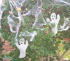 some fake ghost hanging from a tree outside