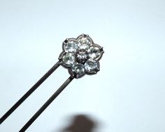 A gorgeous antique Georgian hair decoration. A double prong pin with a hinged top on the form of a flower, setw ith brilliant old black dot paste stones. An elegant period jewel, perfect for adorning the hair on a special occasion. The flower is set in silver, the prongs are possibly a stronger metal. A stunning piece that glistens and flickers on the light. Lovely vintage condition, flower measures 1.5cm diameter, prongs 9.5cm. Lovely rare piece. Diamond Hair Pins, Diamond Hair, Flower Hair Pin, Hair Decorations, Decoration Wedding, Hair Pin, Black Dots, Flower Hair, Hair Piece