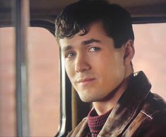 a man sitting in the back seat of a car