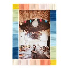 an image of a room that has been decorated with multicolored sticks and paper