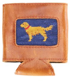 a brown leather wallet with a yellow dog embroidered on the front and blue linings