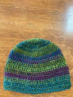 This listing is for a beautiful crocheted hat. The yarn is nice and soft. The hat is made from acrylic yarn and has beautiful green tones in it. There is also some wine and teal colors hinted. It is a wonderful combination of colors. The hat is appropriate for men or women and would look fabulous on both!  The hat measures 8 inches from crown to brim and with fit a 22-23 inch head.  Made in a smoke free home! To care for the hat, machine wash cold. Do not bleach. This hat can also be dry cleaned Green Adjustable Crochet Beanie, Green Crochet Hat In Acrylic Yarn, Green Crochet Beanie Hat (one Size Fits Most), Green Crochet Beanie Hat, One Size, Green Crochet Beanie One Size Fits Most, Green Yarn Beanie One Size Fits Most, Green Yarn Beanie Cap, Green Crochet Hat, One Size Fits Most, Green Yarn Beanie One Size