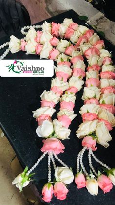 flowers and pearls are laid out on a table for display at a wedding or special event