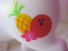 a close up of a plastic object with a pineapple design on it's side