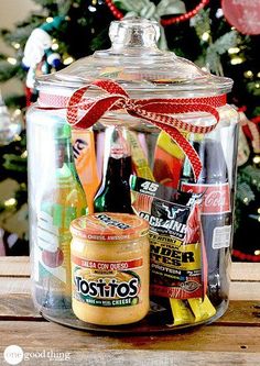 a jar with food in it sitting on top of a table next to a christmas tree