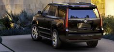 a black suv parked in front of a house