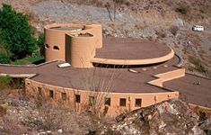 an aerial view of a circular building in the desert