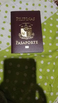 a passport sitting on top of a polka dot blanket