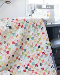 a sewing machine is sitting next to a quilt