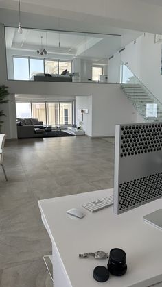 a white table with a laptop and keyboard on it