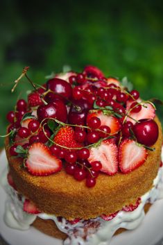 a cake with strawberries and cherries on top