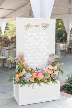 an outdoor ceremony with flowers and greenery on the side of the sign that says, life is good