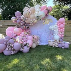 balloons and flowers are arranged on the lawn