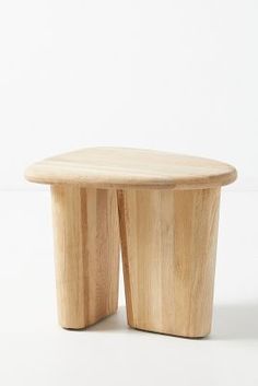 a small wooden table sitting on top of a white floor